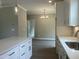 Beautiful kitchen with quartz countertops, white cabinets, stainless steel appliances, and a view into the adjacent dining area at 162 Kirkwall Ln, Selma, NC 27576