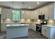 Modern kitchen with quartz countertops, white cabinetry, stainless appliances, and an island perfect for entertaining at 162 Kirkwall Ln, Selma, NC 27576