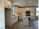 Well-appointed kitchen showcasing white cabinets, modern appliances, and a functional island with a breakfast bar at 162 Kirkwall Ln, Selma, NC 27576