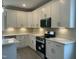Stylish kitchen featuring stainless steel appliances, white quartz countertops and modern white cabinets at 162 Kirkwall Ln, Selma, NC 27576