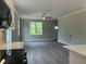 Bright kitchen with white cabinets and stainless steel appliances seamlessly connected to a living space at 162 Kirkwall Ln, Selma, NC 27576