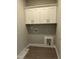 A practical laundry room features upper cabinets and hookups for washer and dryer, maximizing space and functionality at 162 Kirkwall Ln, Selma, NC 27576