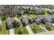 An aerial view showcases the meticulously landscaped yards and diverse architectural styles of homes in this neighborhood at 1637 Hasentree Villa Ln, Wake Forest, NC 27587