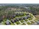 An aerial view displays a well-planned neighborhood with lush greenery and a serene lake backdrop at 1637 Hasentree Villa Ln, Wake Forest, NC 27587
