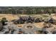 Aerial view of a stone clubhouse with beautiful landscaping and a parking lot, set against a backdrop of a lush golf course at 1637 Hasentree Villa Ln, Wake Forest, NC 27587