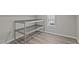 Well-lit attic storage area with wire shelves and finished wood flooring for added convenience at 1637 Hasentree Villa Ln, Wake Forest, NC 27587