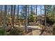 Relaxing backyard patio with a shade canopy surrounded by mature trees and a black metal fence at 1637 Hasentree Villa Ln, Wake Forest, NC 27587