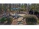 Inviting backyard patio with shade canopies, stone pathway, and lush landscaping at 1637 Hasentree Villa Ln, Wake Forest, NC 27587