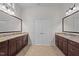 Double vanity bathroom features granite countertops, dark wood cabinets, and ample storage in this updated design at 1637 Hasentree Villa Ln, Wake Forest, NC 27587