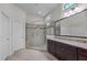 Elegant bathroom featuring a tiled walk-in shower, granite countertop, and stylish vanity with a large mirror at 1637 Hasentree Villa Ln, Wake Forest, NC 27587