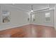 Bright bedroom with hardwood floors, neutral paint, crown molding and plentiful natural light from shuttered windows at 1637 Hasentree Villa Ln, Wake Forest, NC 27587