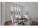 Cozy breakfast nook with plantation shutters and a modern chandelier creates a bright and inviting dining space at 1637 Hasentree Villa Ln, Wake Forest, NC 27587