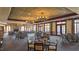 The dining room features elegant lighting, sophisticated decor, and ample seating for a luxurious dining experience at 1637 Hasentree Villa Ln, Wake Forest, NC 27587