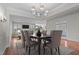 Elegant dining room features a chandelier, hardwood floors, and a neutral color palette, creating a welcoming ambiance at 1637 Hasentree Villa Ln, Wake Forest, NC 27587