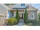 Inviting front entrance framed by manicured greenery, stone accents, and a covered porch with handsome wooden door at 1637 Hasentree Villa Ln, Wake Forest, NC 27587