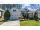 Charming two-story home featuring a well-manicured lawn, attached two-car garage, and lovely landscaping at 1637 Hasentree Villa Ln, Wake Forest, NC 27587