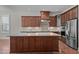 Gourmet kitchen with granite countertops, custom cabinets, stainless steel appliances, and a large center island at 1637 Hasentree Villa Ln, Wake Forest, NC 27587