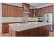 Spacious kitchen with granite countertops, custom cabinets, a stainless steel appliance package, and a functional island at 1637 Hasentree Villa Ln, Wake Forest, NC 27587