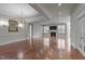 Spacious living room features hardwood flooring, fireplace and elegant chandelier lighting at 1637 Hasentree Villa Ln, Wake Forest, NC 27587