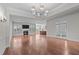 Spacious living room with a fireplace, hardwood flooring, and open layout, perfect for entertaining guests at 1637 Hasentree Villa Ln, Wake Forest, NC 27587