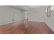 Open-concept living area featuring hardwood floors, elegant lighting, and a neutral color scheme for versatile decor at 1637 Hasentree Villa Ln, Wake Forest, NC 27587
