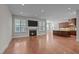Inviting living room with fireplace, built-ins, and an open-concept design flowing into the modern kitchen at 1637 Hasentree Villa Ln, Wake Forest, NC 27587