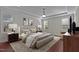 Relaxing main bedroom featuring a tray ceiling, hardwood floors, soft lighting, and custom decor for ultimate comfort at 1637 Hasentree Villa Ln, Wake Forest, NC 27587
