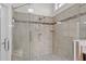 Tiled walk-in shower featuring grab bar and custom tile work for a luxurious and accessible bathing experience at 1637 Hasentree Villa Ln, Wake Forest, NC 27587