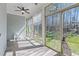 Bright sunroom with floor-to-ceiling windows offering serene views of the lush backyard at 1637 Hasentree Villa Ln, Wake Forest, NC 27587