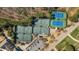 An aerial perspective shows the tennis courts surrounded by lush trees and manicured landscaping at 1637 Hasentree Villa Ln, Wake Forest, NC 27587