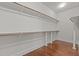 Spacious walk-in closet with wood floors and ample shelving for organized storage and easy access to clothing at 1637 Hasentree Villa Ln, Wake Forest, NC 27587