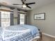 Cozy bedroom featuring neutral paint, two windows with custom curtains, and a ceiling fan at 2019 Falls River Ave, Raleigh, NC 27614