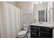 Functional bathroom with a shower curtain, toilet, and vanity with modern fixtures at 211 Monarda Way, Hillsborough, NC 27278