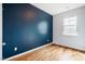 Bedroom with hardwood floors and a large window at 211 Monarda Way, Hillsborough, NC 27278