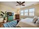 Comfortable bedroom featuring a ceiling fan, area rug and bright natural light at 211 Monarda Way, Hillsborough, NC 27278