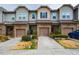 Attractive townhome exterior with individual garages and well-maintained lawns at 211 Monarda Way, Hillsborough, NC 27278