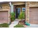 Inviting townhouse exterior with a stone facade, well-manicured landscaping, and covered entryway at 211 Monarda Way, Hillsborough, NC 27278