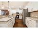 Bright kitchen featuring granite countertops, stainless steel appliances, and white cabinets at 211 Monarda Way, Hillsborough, NC 27278