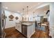 Open kitchen featuring granite countertops and views into the dining and living area at 211 Monarda Way, Hillsborough, NC 27278