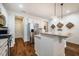 Well-lit kitchen with stainless steel appliances, granite countertops, and modern fixtures at 211 Monarda Way, Hillsborough, NC 27278