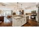 Modern kitchen open to the living area, featuring an island and stainless steel appliances at 211 Monarda Way, Hillsborough, NC 27278