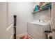 Efficient laundry room with modern washer and dryer and convenient shelving for storage at 211 Monarda Way, Hillsborough, NC 27278