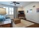 Bright living room featuring a comfy sofa, wooden coffee table, ceiling fan, and plenty of natural light from the windows at 211 Monarda Way, Hillsborough, NC 27278