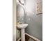 Stylish powder room featuring pedestal sink, framed art, and hardwood floors at 211 Monarda Way, Hillsborough, NC 27278