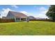 A view of the home's backyard featuring a covered patio, landscaping, and lawn space at 217 Walker Grv Ln, Lillington, NC 27546