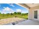 View of the home's backyard featuring a stone patio, landscaping, and generous lawn space at 217 Walker Grv Ln, Lillington, NC 27546