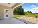 The covered patio overlooks the backyard with stone patio and lush lawn at 217 Walker Grv Ln, Lillington, NC 27546