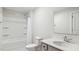 Clean bathroom featuring single vanity, framed mirror, and shower over bathtub with shower curtain at 217 Walker Grv Ln, Lillington, NC 27546