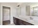 Bright bathroom featuring double vanity, walk-in closet, and tiled walk-in shower with glass door at 217 Walker Grv Ln, Lillington, NC 27546