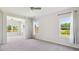 Large bedroom with a ceiling fan and multiple windows, providing lots of natural light at 217 Walker Grv Ln, Lillington, NC 27546